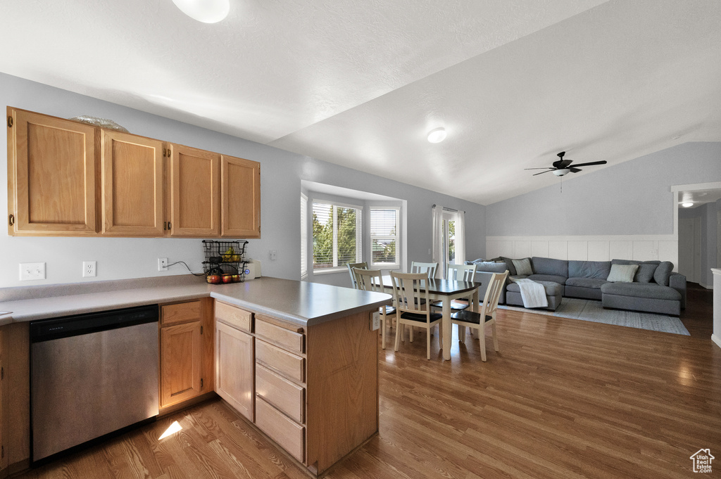 Kitchen featuring ceiling fan, wood finished floors, a peninsula, and dishwasher