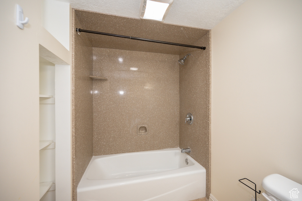 Full bathroom with toilet and shower / bath combination