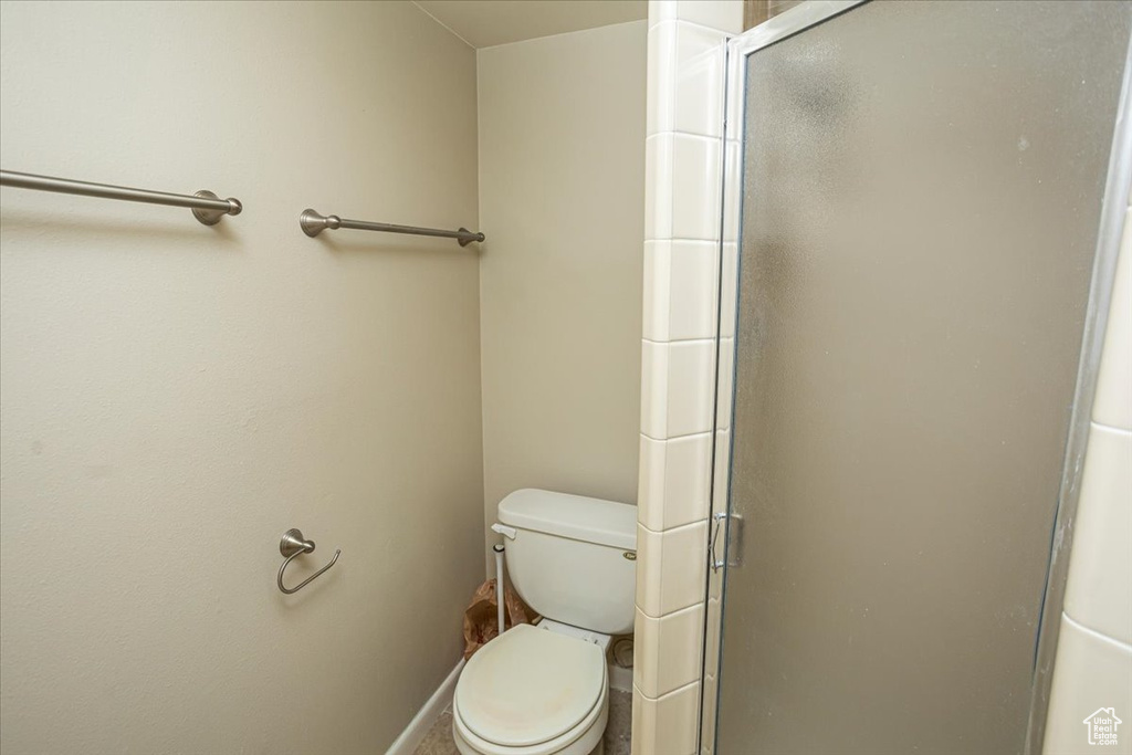 Bathroom featuring toilet and a shower stall
