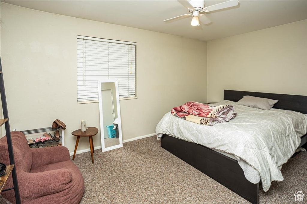 Bedroom featuring baseboards, ceiling fan, and carpet