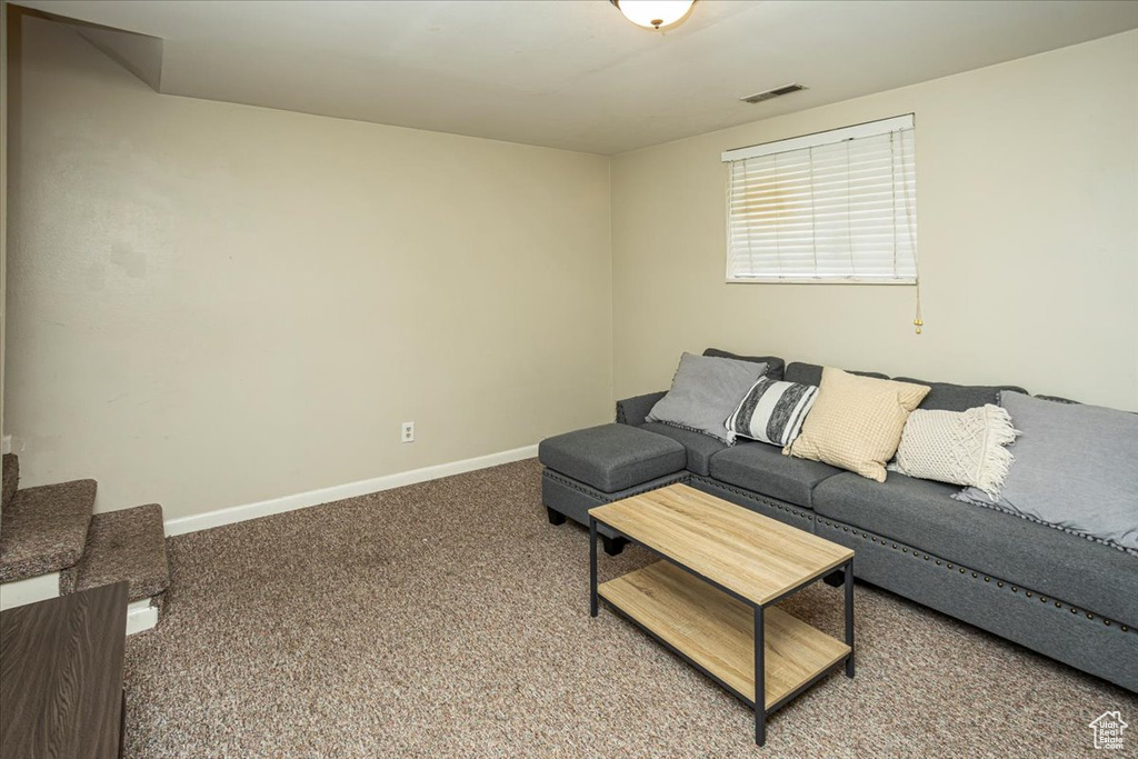 Living room featuring carpet flooring, visible vents, and baseboards