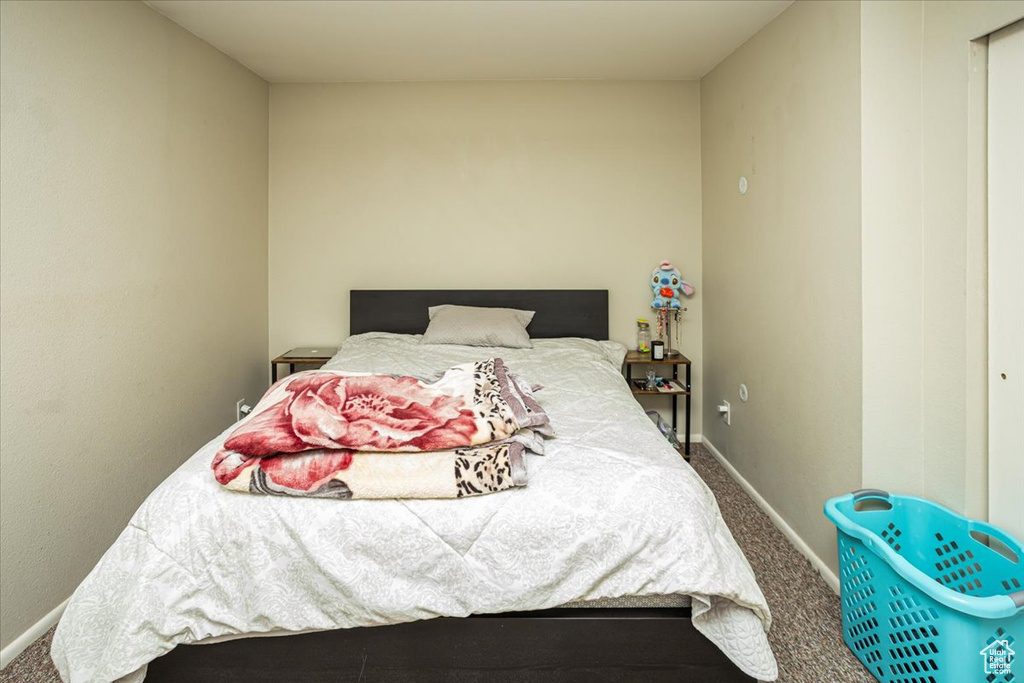 Carpeted bedroom featuring baseboards