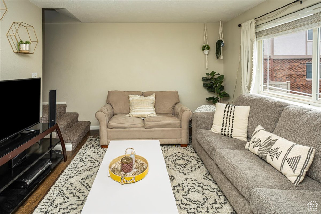 Living area with baseboards and wood finished floors