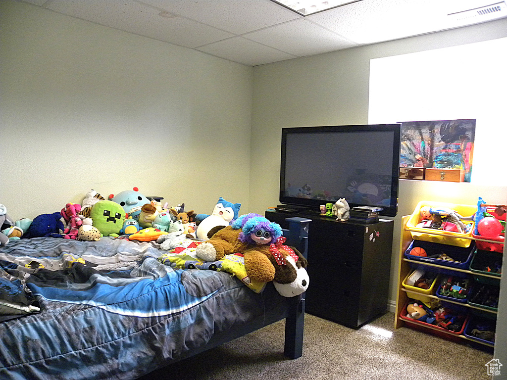 Carpeted bedroom with a drop ceiling