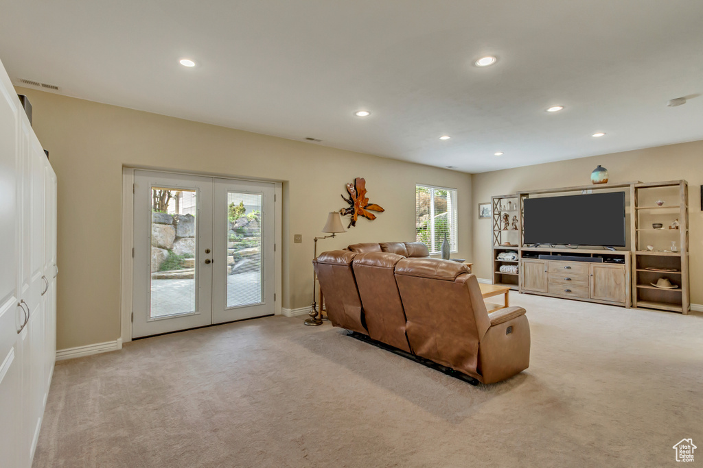 Living room with light colored carpet, french doors, and recessed lighting