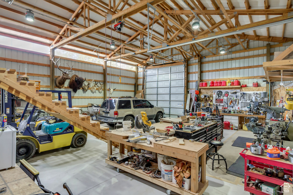 Garage featuring a workshop area and metal wall