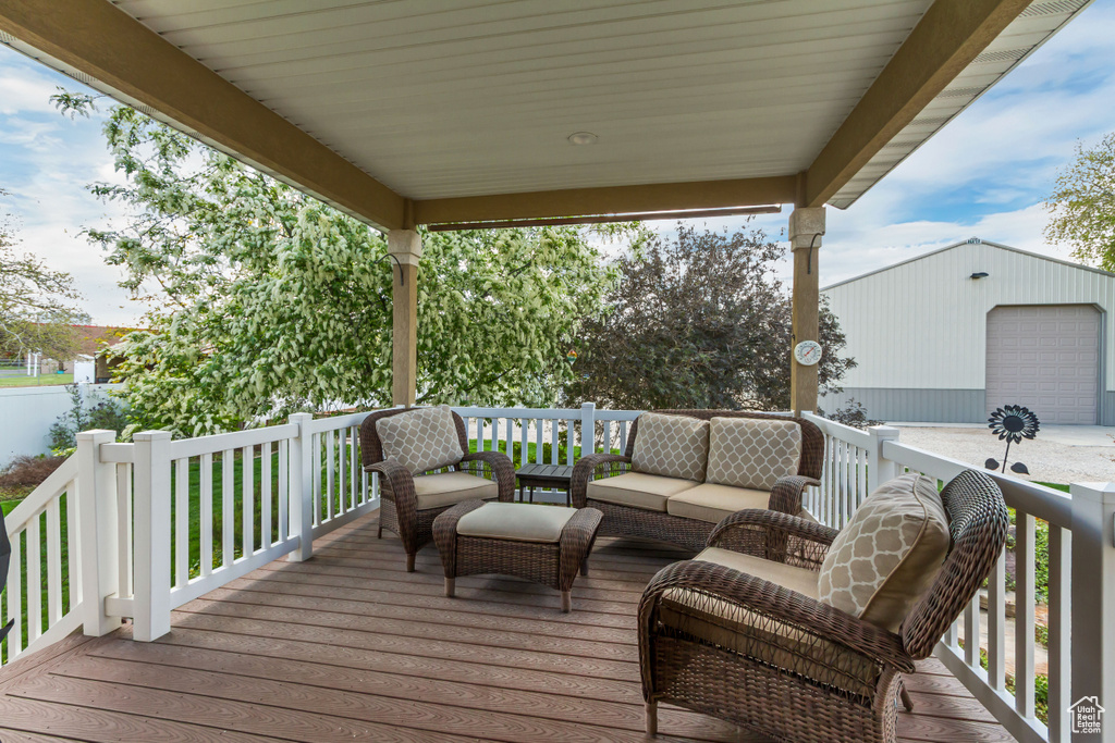 Wooden terrace with an outdoor structure and an outdoor hangout area
