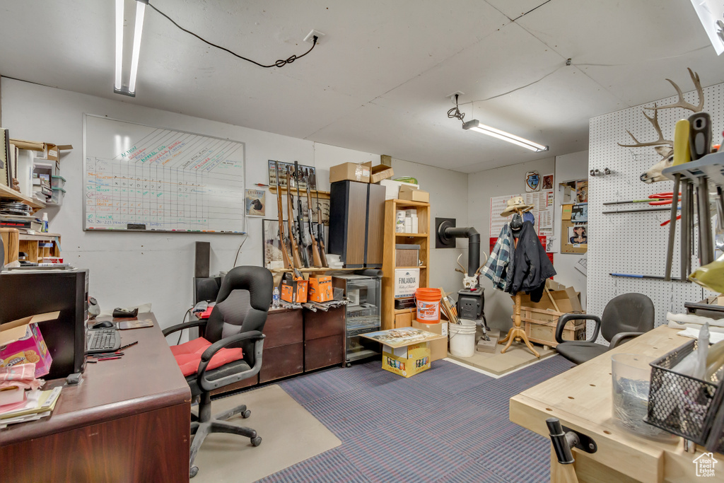 Office space featuring a workshop area and carpet