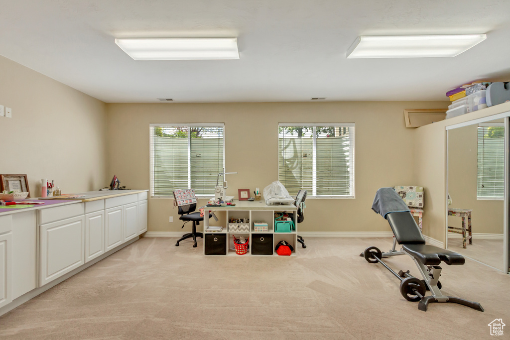 Home office featuring baseboards and light carpet