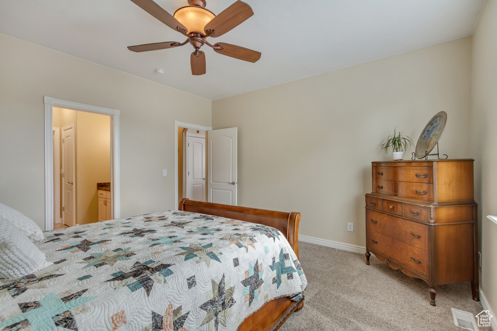 Bedroom with ceiling fan, baseboards, and light carpet