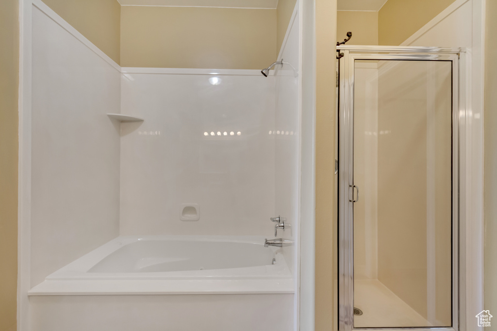 Bathroom with an enclosed shower and a tub to relax in