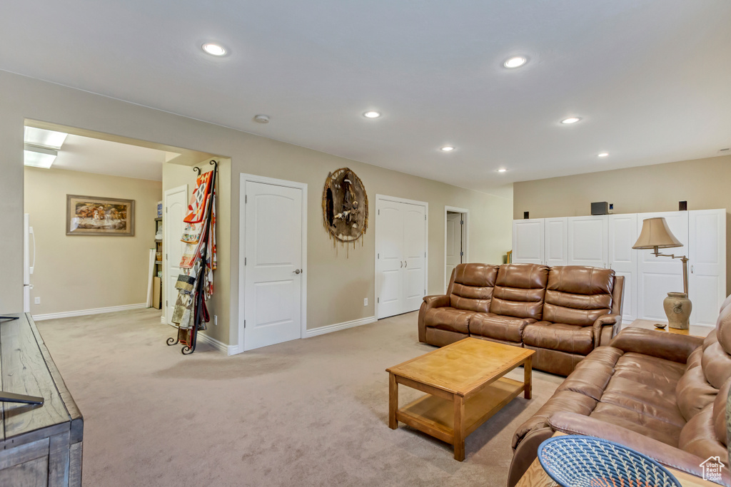 Living area featuring recessed lighting, light carpet, and baseboards