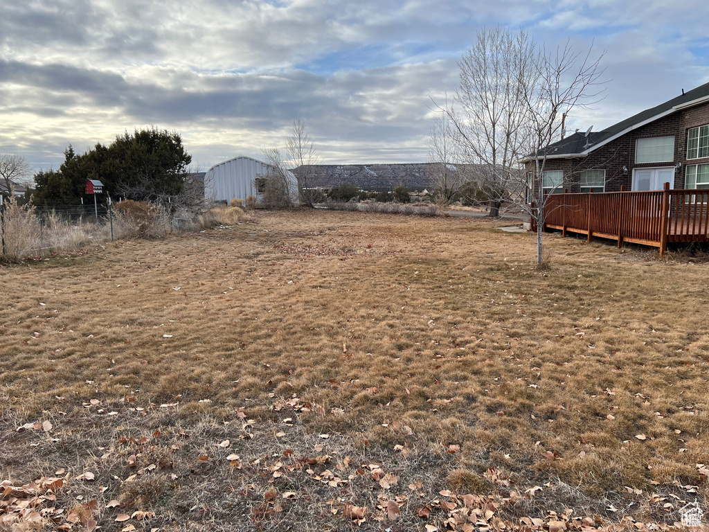 View of yard with a wooden deck