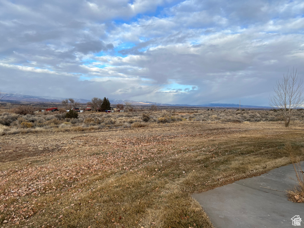 View of yard with a rural view