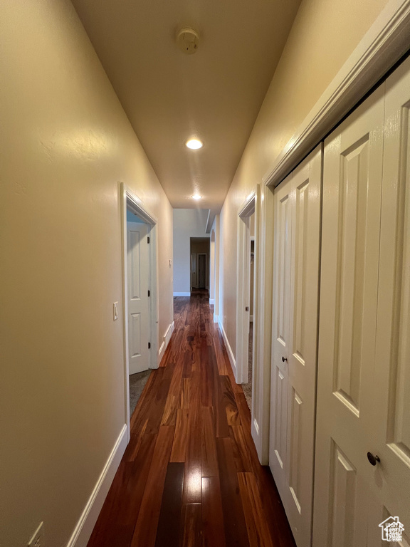 Hall featuring recessed lighting, dark wood finished floors, and baseboards