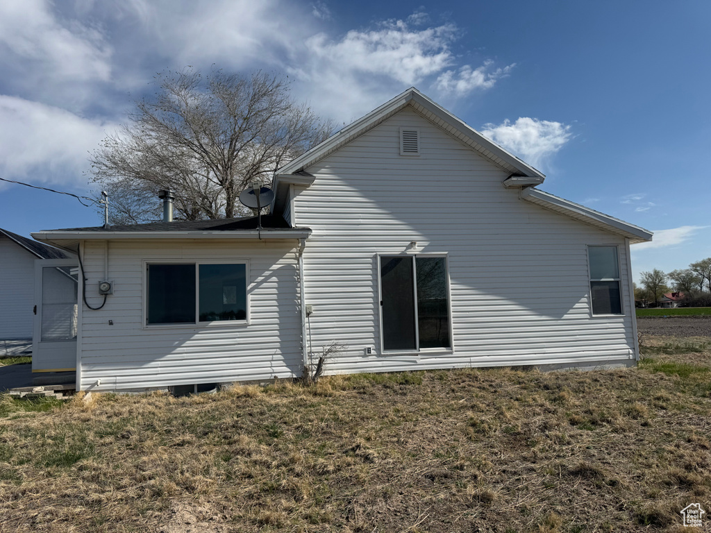 Rear view of house with a lawn