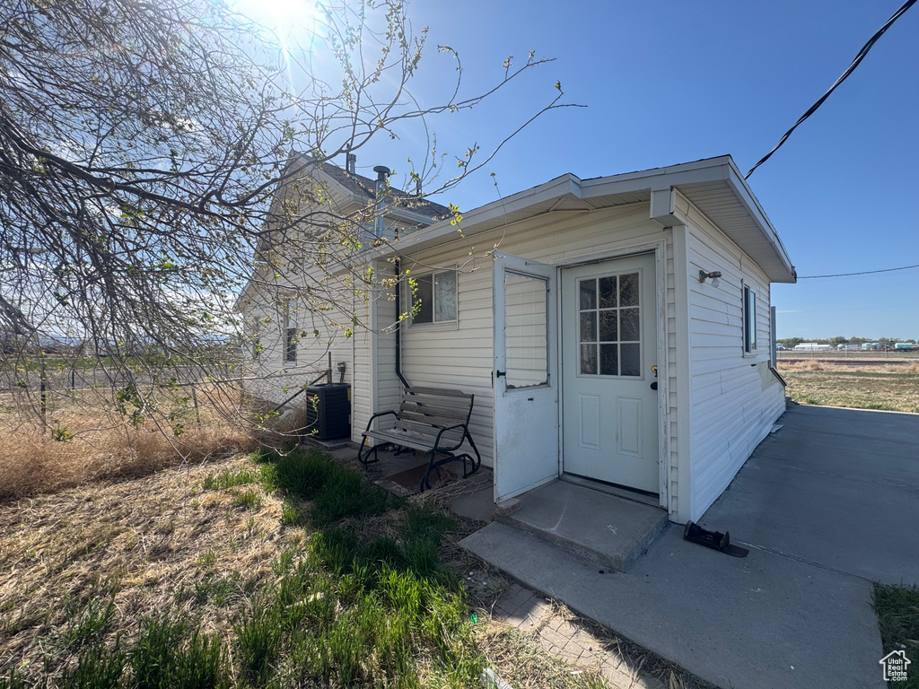 View of outbuilding with central AC and fence
