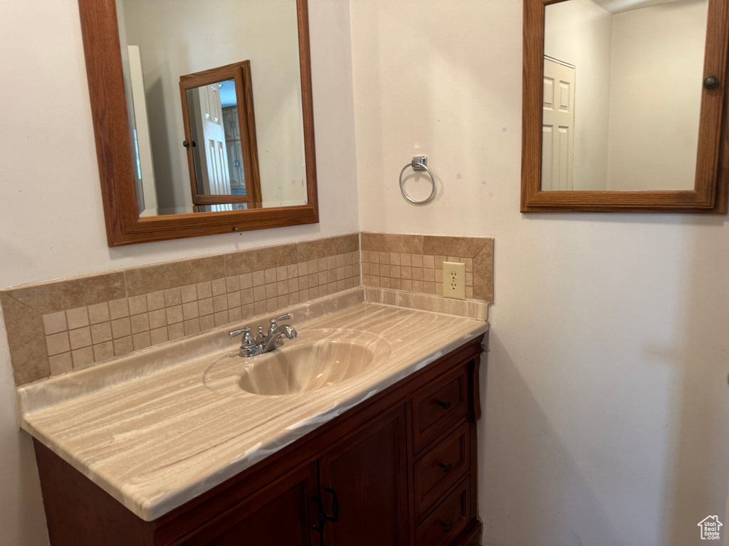 Bathroom with vanity and decorative backsplash