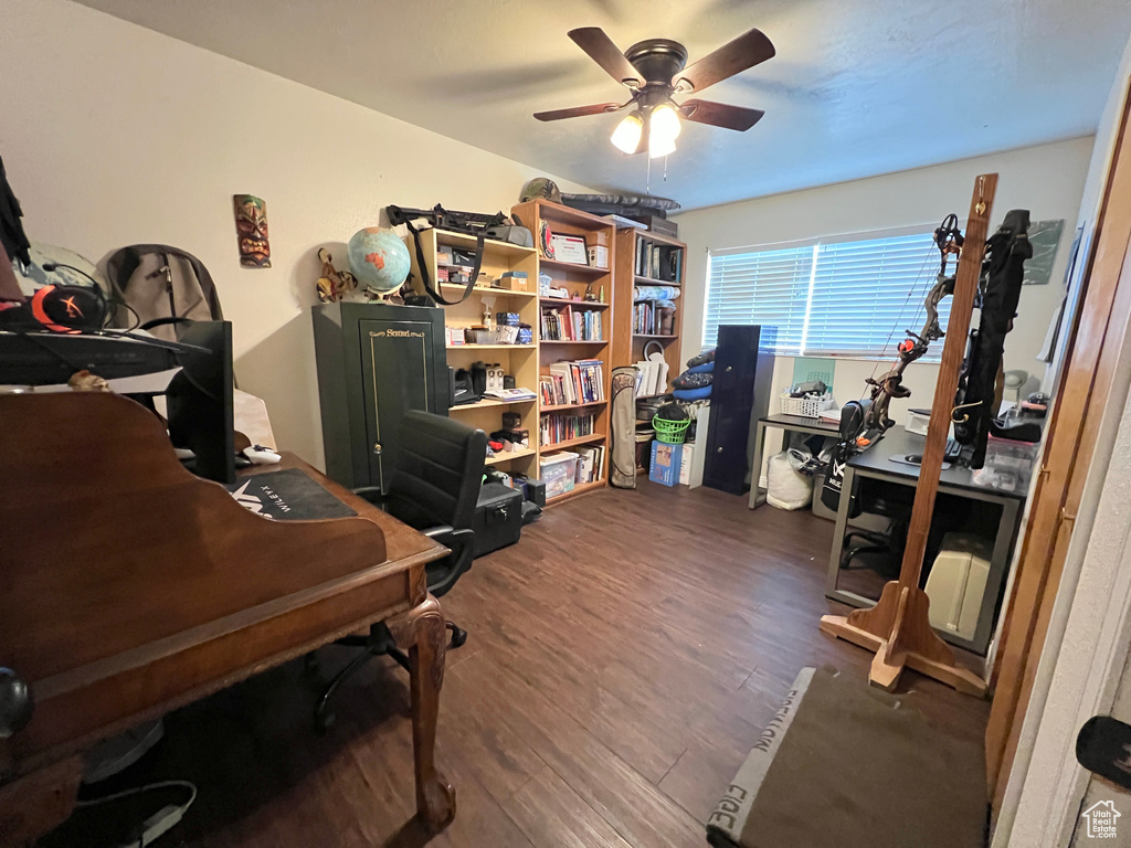 Home office featuring ceiling fan and dark wood-style flooring
