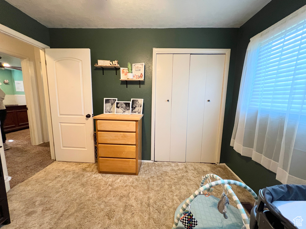 Carpeted bedroom featuring a closet