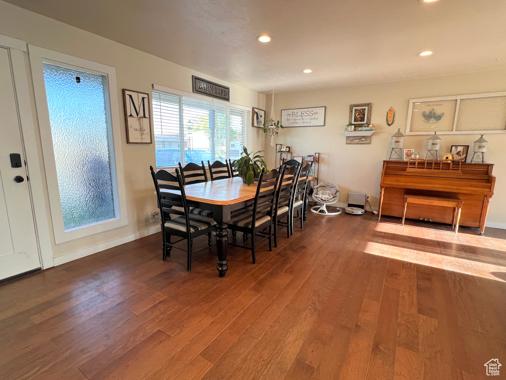 Dining space with wood finished floors and recessed lighting