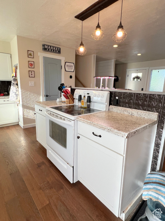 Kitchen featuring pendant lighting, white cabinetry, white range with electric cooktop, and dark wood finished floors