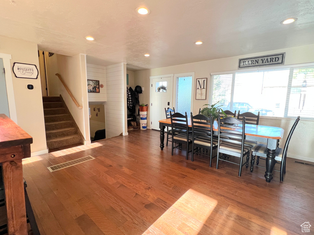 Dining room with recessed lighting, visible vents, stairway, and wood finished floors