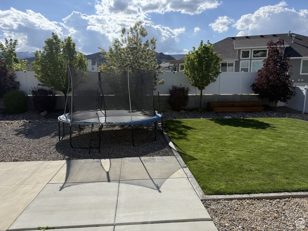 View of yard featuring a trampoline