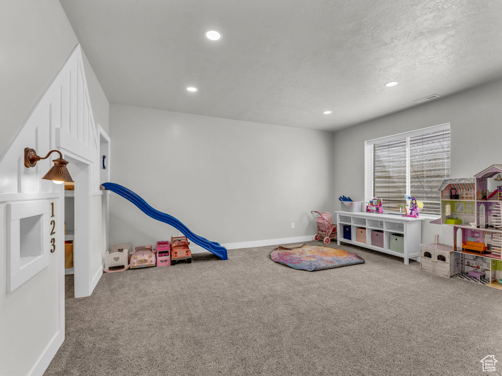 Rec room with carpet, recessed lighting, a textured ceiling, and baseboards