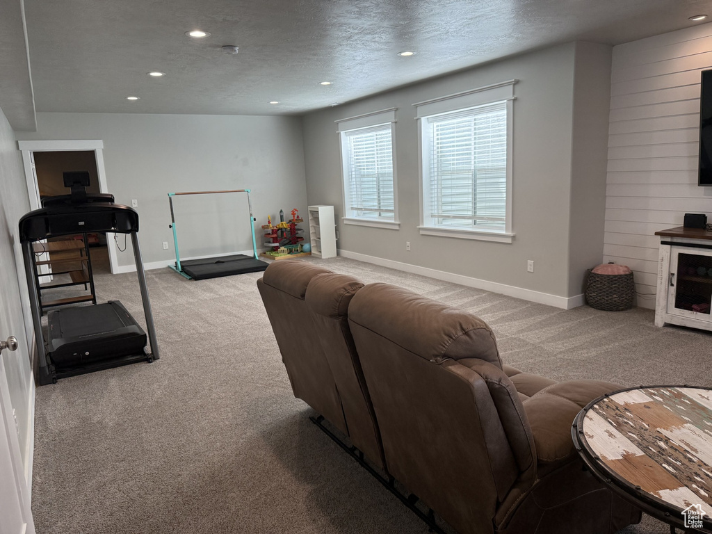 Living area featuring carpet, recessed lighting, baseboards, and a textured ceiling