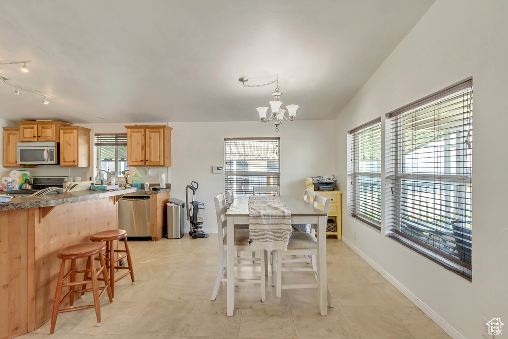 Dining space with a chandelier and baseboards