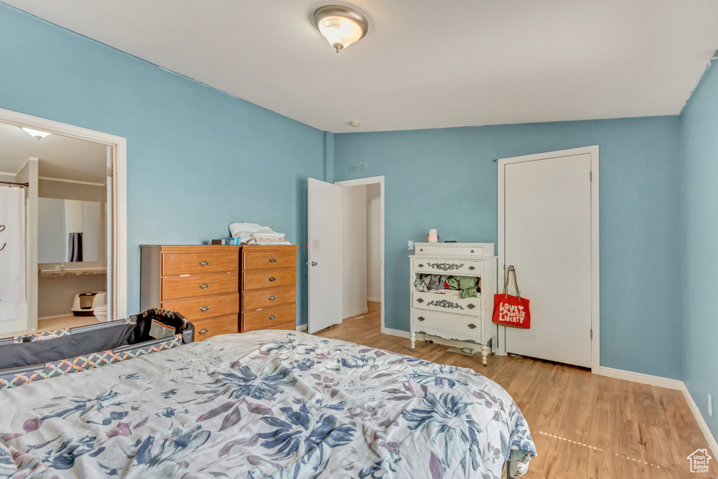 Bedroom featuring baseboards and wood finished floors