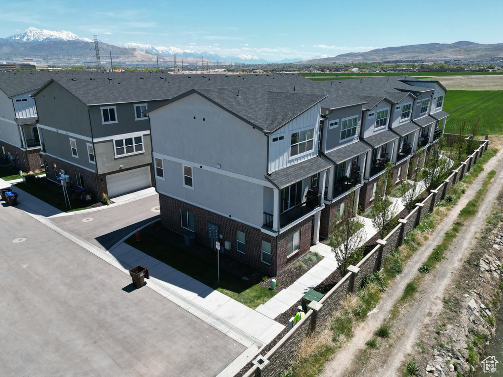 Birds eye view of property with a residential view and a mountain view