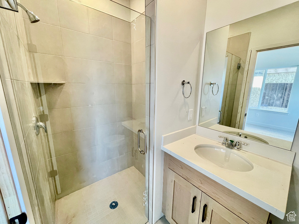 Bathroom with vanity and a stall shower