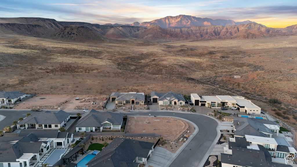 Drone / aerial view featuring view of desert, a mountain view, and a residential view