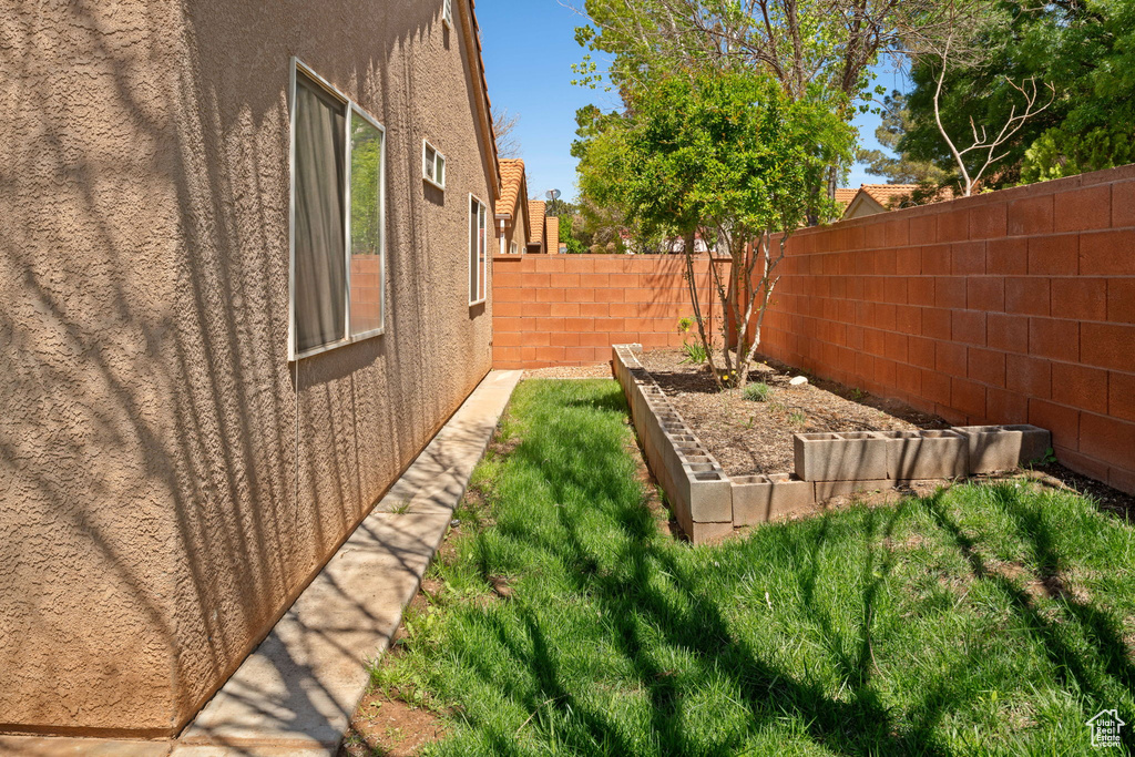 View of yard with a garden and a fenced backyard