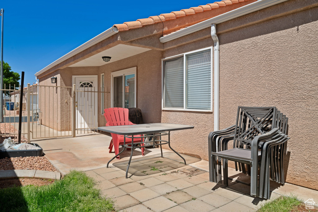 View of patio with a gate and fence
