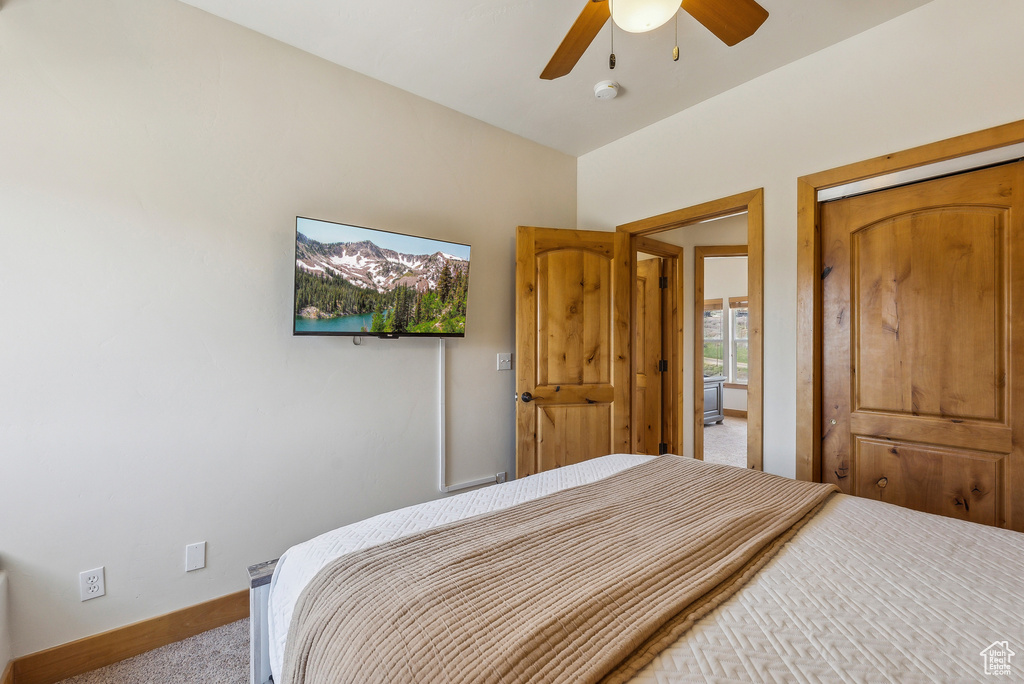 Bedroom with a ceiling fan, carpet, and baseboards
