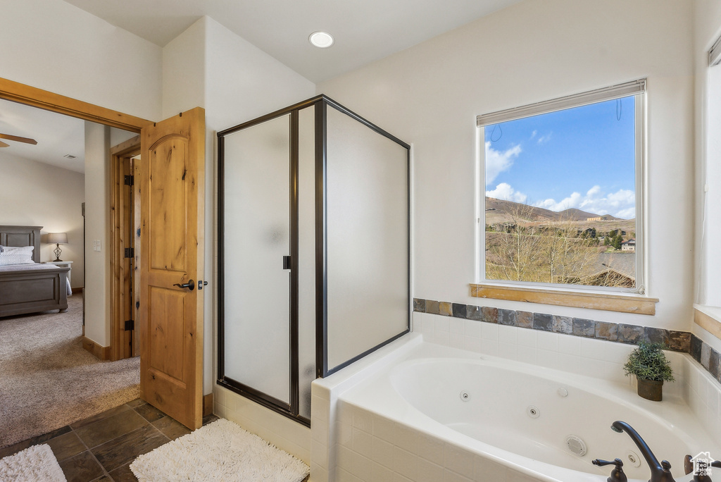 Ensuite bathroom with a stall shower, a jetted tub, connected bathroom, and a mountain view