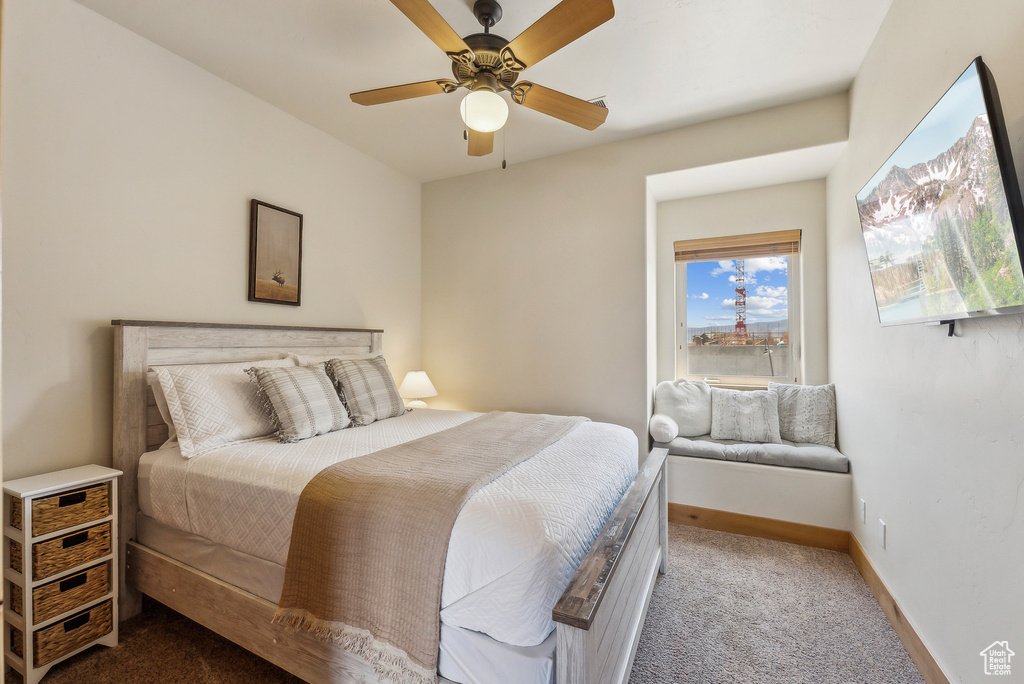 Bedroom featuring a ceiling fan, carpet flooring, and baseboards