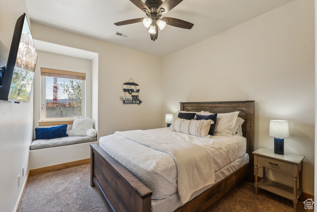 Carpeted bedroom featuring visible vents, ceiling fan, and baseboards