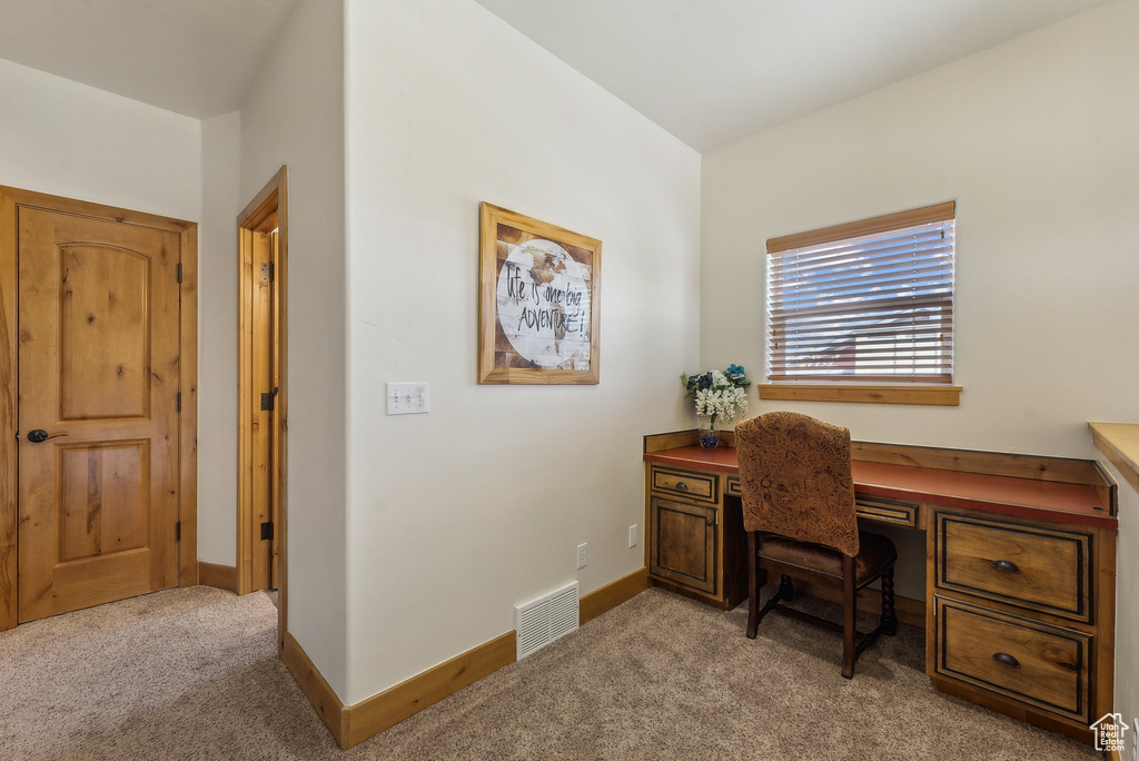 Office featuring baseboards, visible vents, and light colored carpet