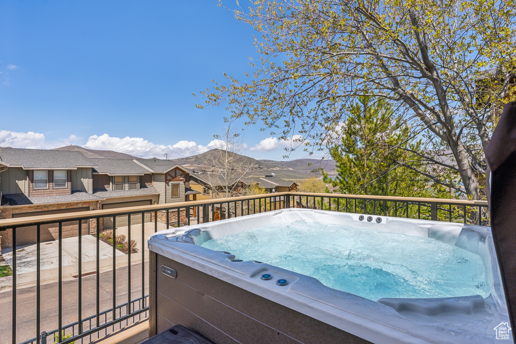 Exterior space with a mountain view and a hot tub