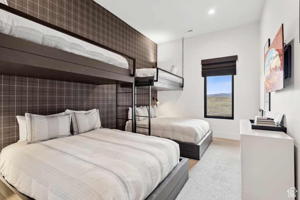 Carpeted bedroom with recessed lighting, visible vents, and baseboards