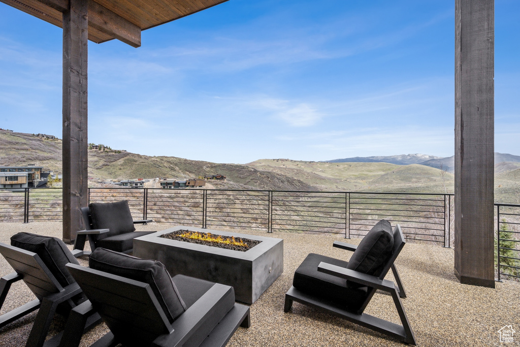 View of patio with a fire pit and a mountain view