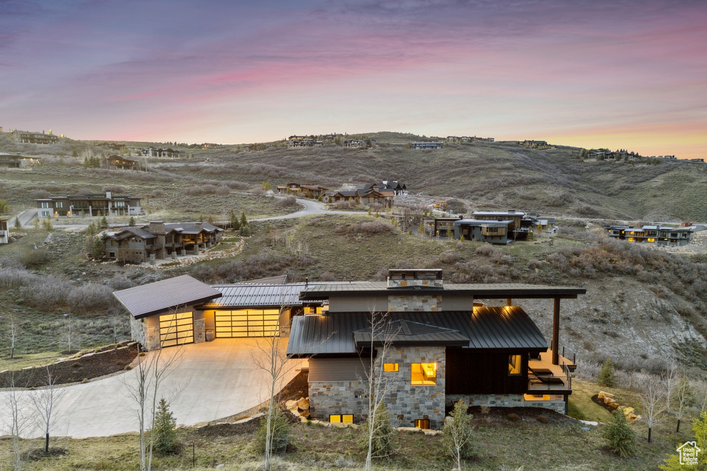Exterior space featuring a standing seam roof, metal roof, a mountain view, and stone siding