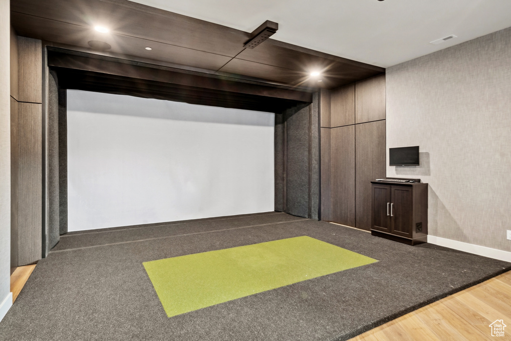 Playroom featuring recessed lighting, wood finished floors, and golf simulator