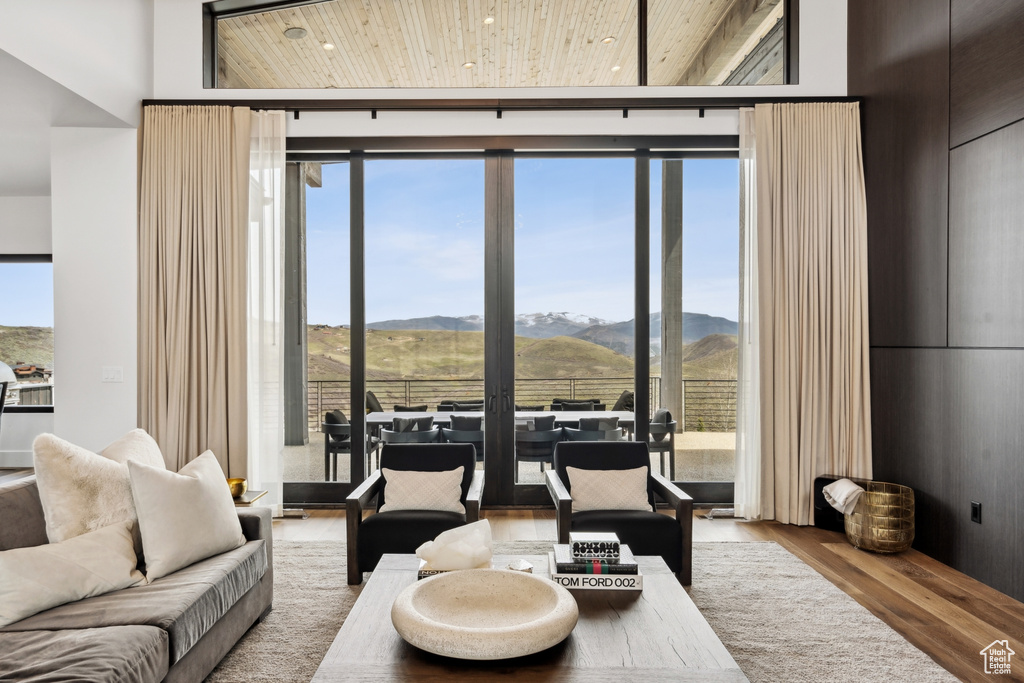Living area featuring a mountain view, wood finished floors, and wood ceiling