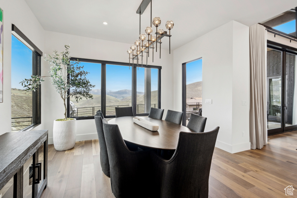 Dining area featuring a mountain view, wood finished floors, and baseboards