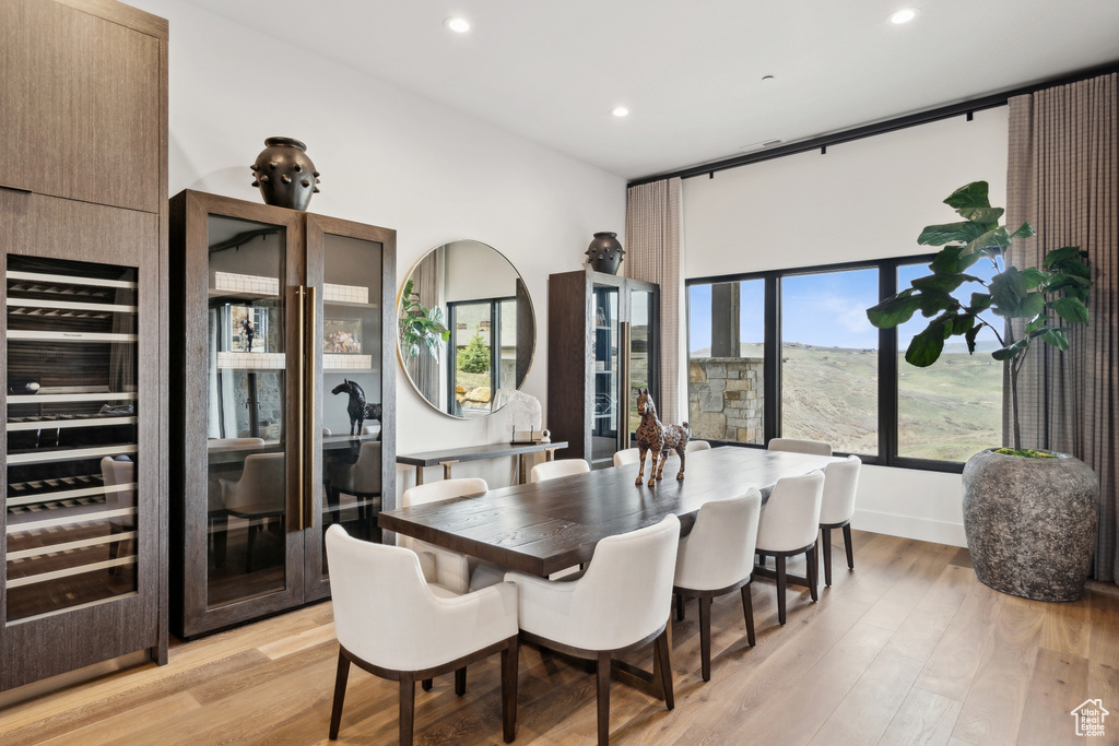 Dining area with recessed lighting and light wood finished floors